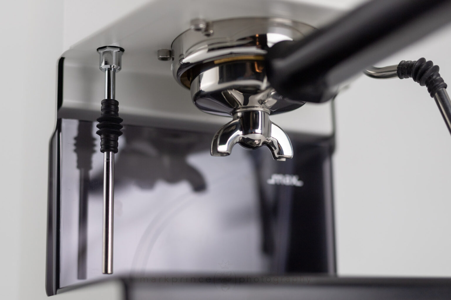 Looking up at the Gaggia Classic portafilter spouts while it sits in the machine