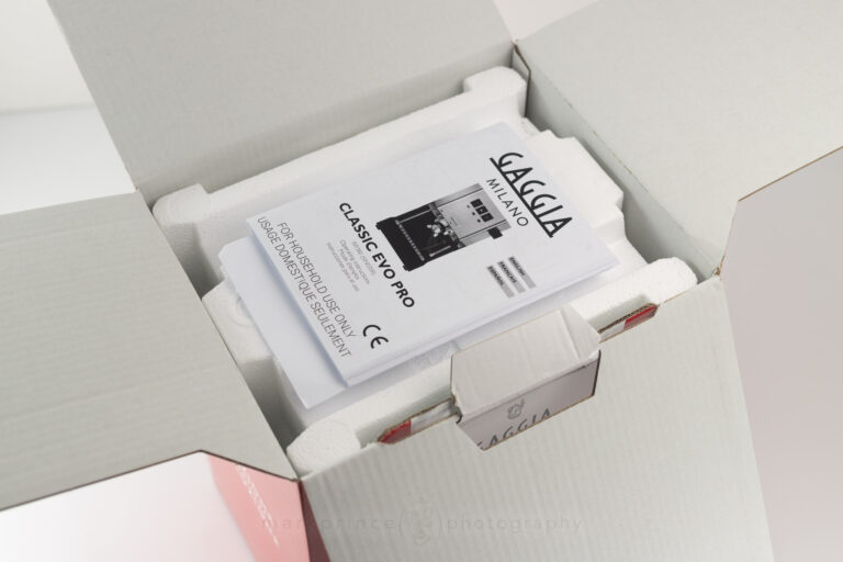 Opening the lid of the Gaggia Classic Evo Pro reveals the product manual and warranty.