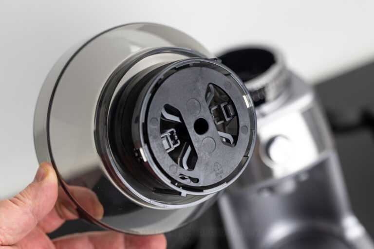 The underside of the hopper showing the assembly that shuts the bean path when you remove it from the grinder.