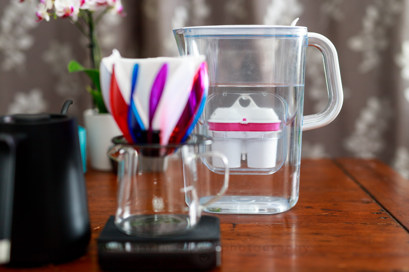 A water filter with a pour over brewing method pictured in front of it.