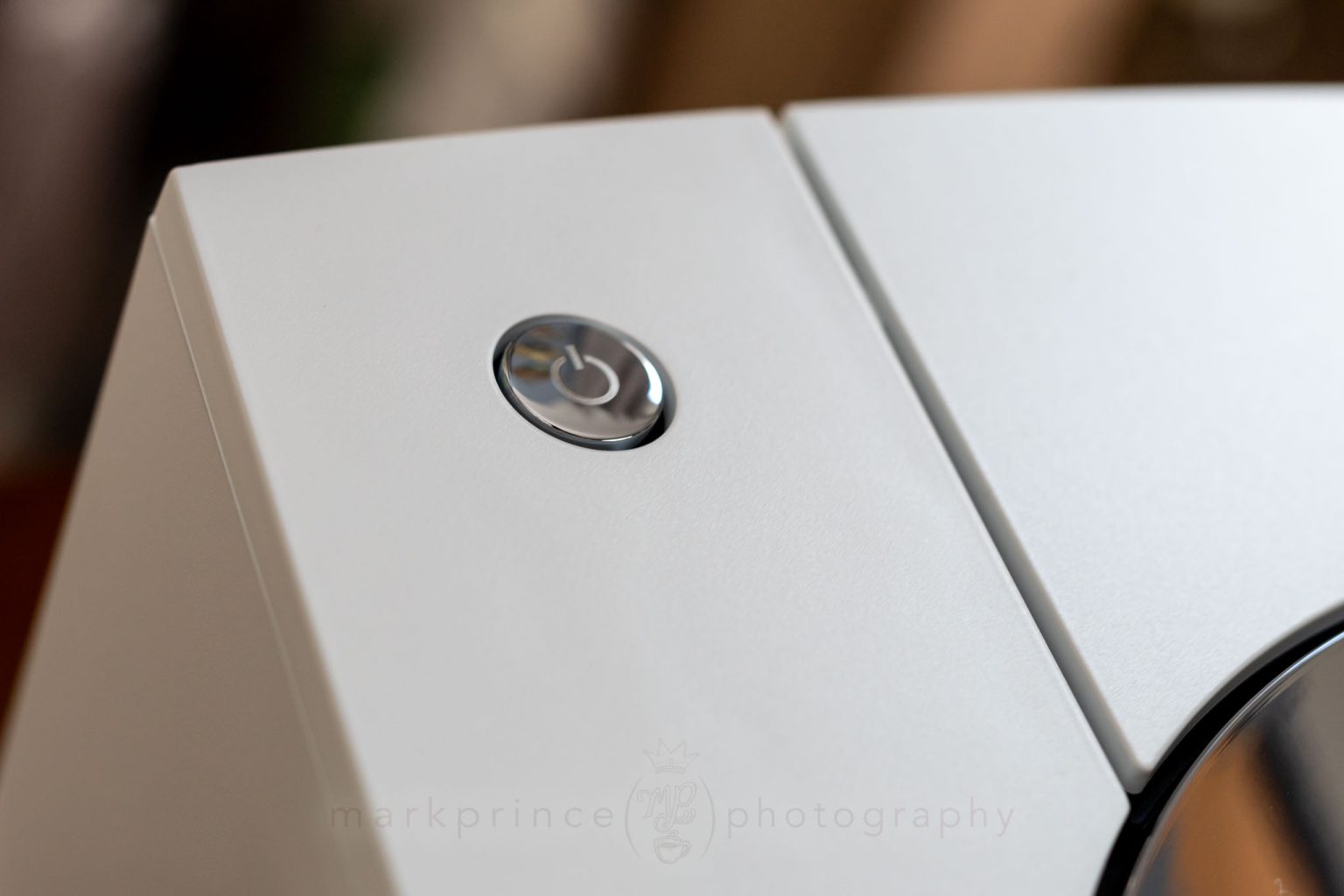 The machine's main power button, towards the back left on the top.